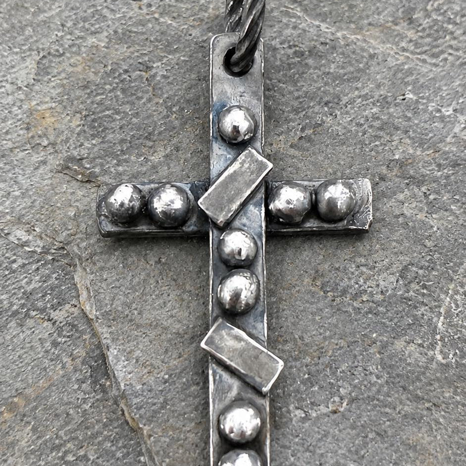Silver artisan rustic cross pendant with detailed craftsmanship, hanging on a chain, by JJewelryArt.