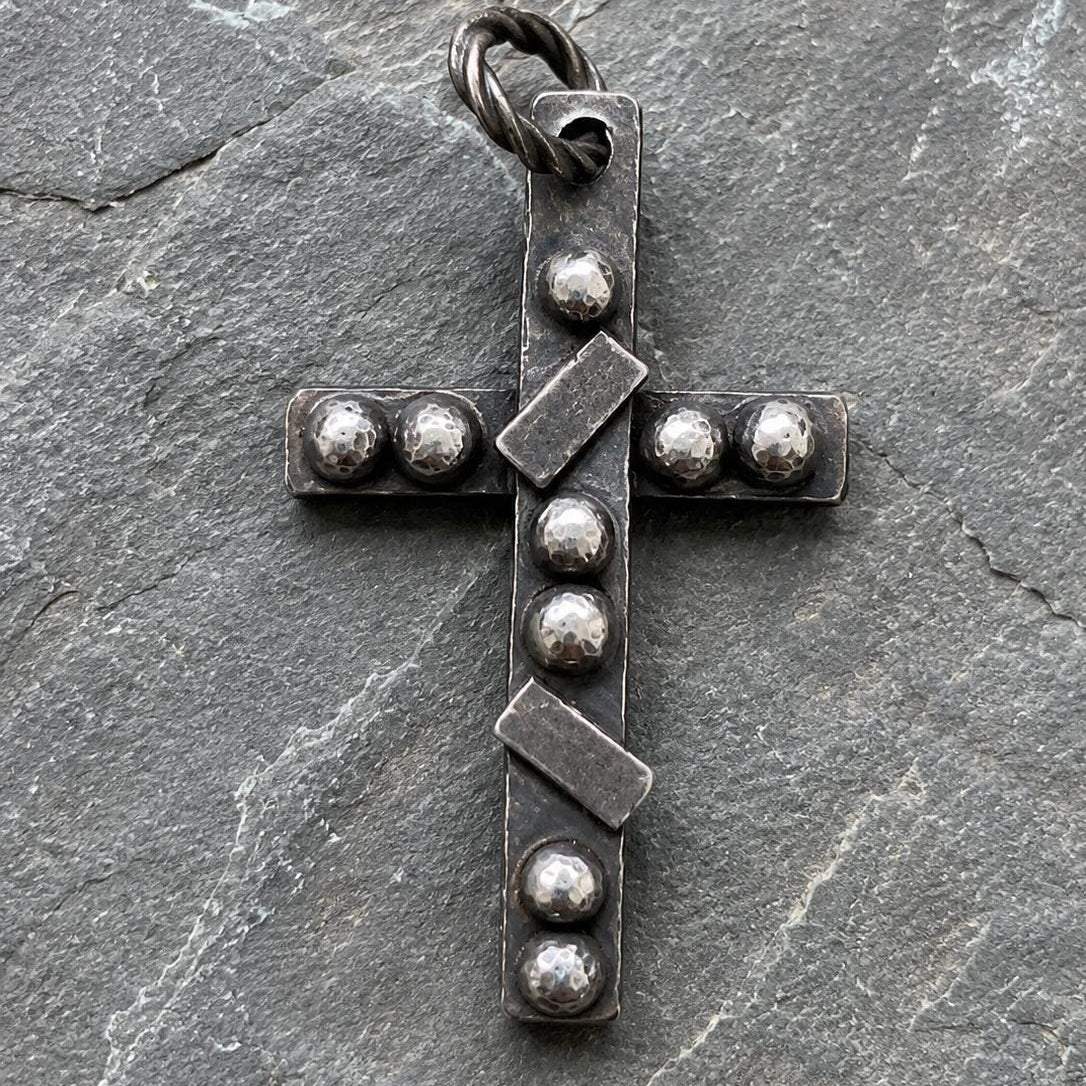 Silver artisan pendant featuring a rustic cross design with intricate detailing, crafted by JJewelryArt.
