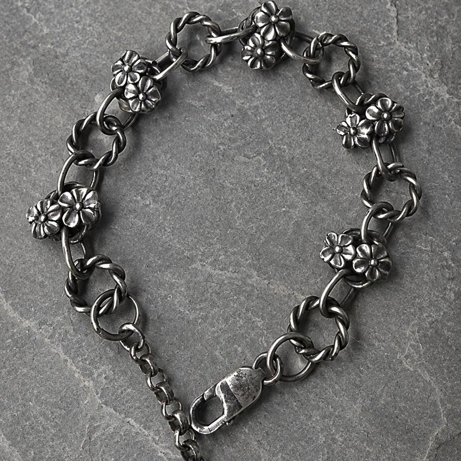 Sterling silver flower bracelet with oxidized floral link design by JJewelryArt, showcasing intricate flower and leaf details.
