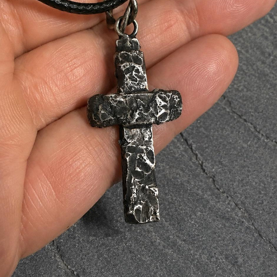 Silver rustic cross pendant by JJewelryArt featuring a textured, handcrafted design on a chain.
